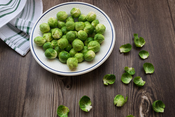 top view of fresh and organic brussel sprouts on a wooden table