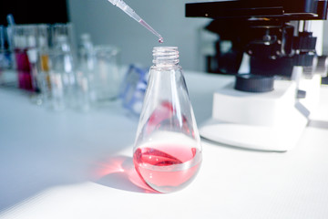 Cropped shot view of  the equipment and science experiments in Laboratory, Chemical substances for research and analyzing a sample under the microscope in laboratory.   
