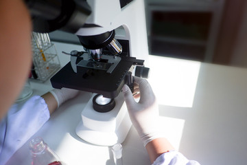 Cropped shot view of  the equipment and science experiments in Laboratory, Chemical substances for research and analyzing a sample under the microscope in laboratory.   