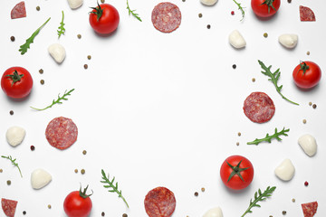 Composition with fresh ingredients and space for text on white background, top view. Pepperoni pizza recipe