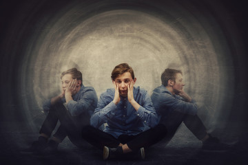Teenage guy seated on the floor suffer split emotions into three different inner personalities....