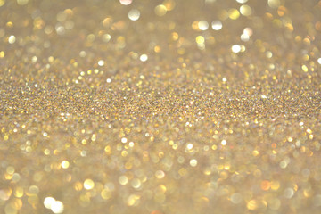 Beautiful Abstract Sparkle Glitter Lights Background. Gold Champagne. Shine Bokeh Effect. For party, holidays, celebration.