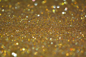Beautiful Abstract Sparkle Glitter Lights Background. Gold Champagne. Shine Bokeh Effect. For party, holidays, celebration.