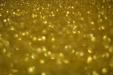 Beautiful Abstract Sparkle Glitter Lights Background. Gold Champagne. Shine Bokeh Effect. For party, holidays, celebration.