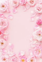 Fototapeta na wymiar Flowers background. beautiful pink roses and petals frame on pink background.Top view.Copy space. Wedding invitation. Holiday concept