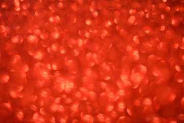 Beautiful Abstract Defocused Sparkle Glitter Lights Background. Red Scarlet. Shine Bokeh Effect. For party, holidays, celebration.