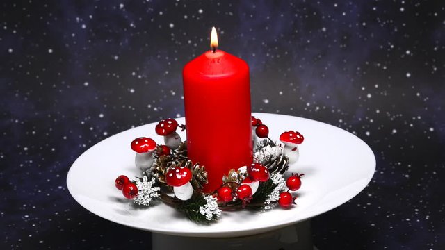 Christmas decoration with advent wreath and burning   candle on turn table