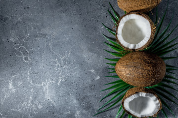 Fototapeta na wymiar ripe chopped coconut on a gray stone background. place for your text