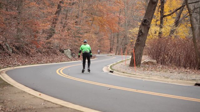 A southbound roller blader and northbound runner on Beach Drive - Rock Creek Park - Washington, DC - Autumn