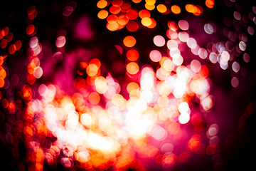 Golden bokeh mixed with diffused red light from the winter Christmas tree in Thailand. Business...