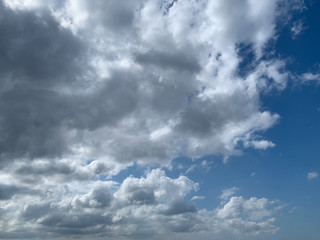 View of dense, heavy, big clouds and blue sky.