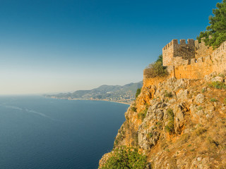 Alanya, Turkey. Beautiful view from the fortress Alanya Castle of the Mediterranean Sea and Cleopatra beach at sunset. Vacation postcard background