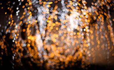 Golden bokeh mixed with diffused white light from the winter Christmas tree in Thailand. Business...