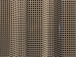 Close up view of silver colored metal mesh background.