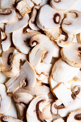 a group of sliced raw mushrooms on white background