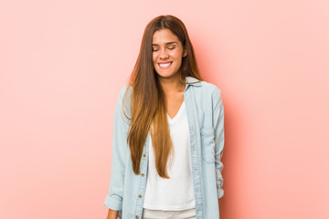 Fototapeta premium Young slim woman laughs and closes eyes, feels relaxed and happy.