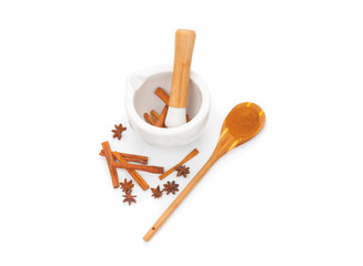 Preparation cinnamon powder in ceramic mortar isolated on white background