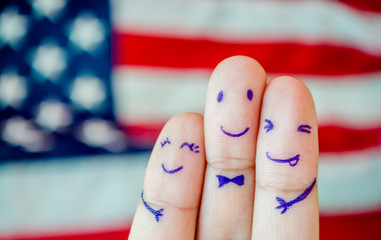 Happy family finger of loving father and mother with son with smiley face on American flag...
