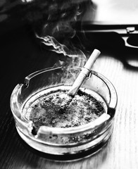 Reel tape recorder for wiretapping. KGB spying conversations. Black gun nearby. Ashtray with a cigarette.