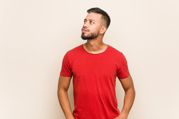 Young south-asian man dreaming of achieving goals and purposes