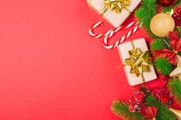 Christmas red background with herringbone and decor. Gold and red jewelry. Top view with space for copy.