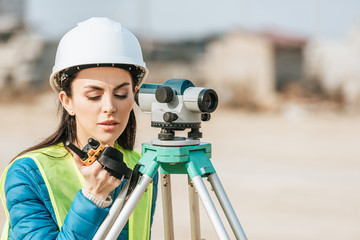 Surveyor with digital level talking on radio set