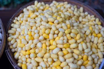 Closed up cocoon of silk in basket