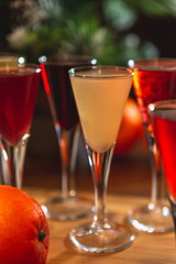 Set of glasses with different colored tinctures made on the basis of fruits and alcohol, a wonderful aperitif before the festive dinner