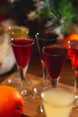 Set of glasses with different colored tinctures made on the basis of fruits and alcohol, a wonderful aperitif before the festive dinner