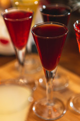 Set of glasses with different colored tinctures made on the basis of fruits and alcohol, a wonderful aperitif before the festive dinner