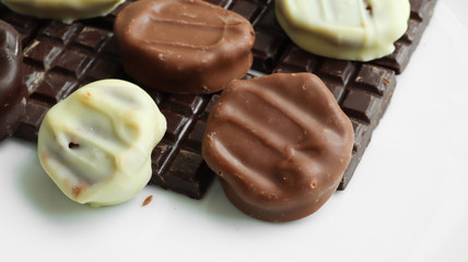Handmade dark, white and milk chocolate close-up on a white background
