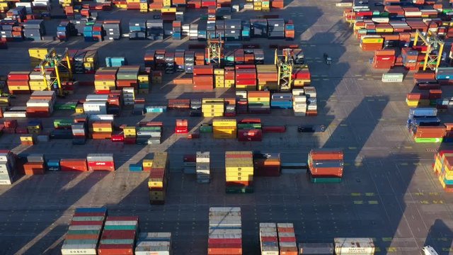 Pile of containers on a loading dock Port of Valencia aerial view Spain sunset 