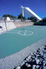 Empty basketball court with solar telescope at Kitt Peak Observatory against clear sky