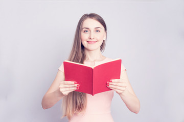 Young student with open book, beautiful girl, portrait, copy space, toned