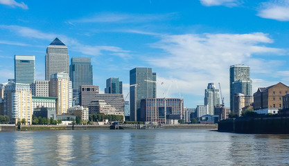 Modern skyscrapers of Canary Wharf, London, United Kingdom. Panoramic cityscape from the Thames river.
