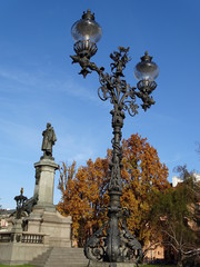Fototapeta na wymiar Antique lamp post with statue