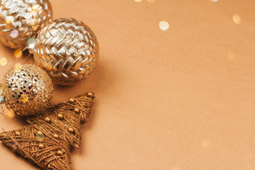 Fototapeta na wymiar Golden christmas toys and balls on a brown background copy space .