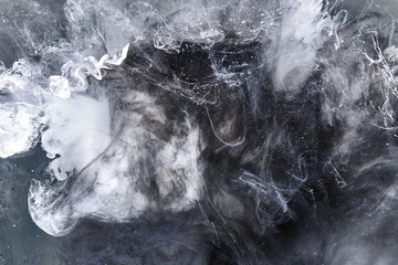 Abstract black and white swirling smoke background. Cumulus thunderclouds, mysterious and frightening sky. Paints colors of depression and negative emotions