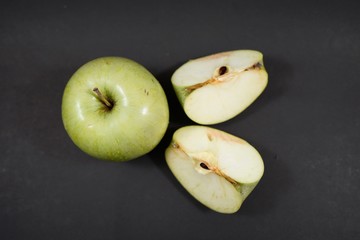 top  green apples slices on black background 
