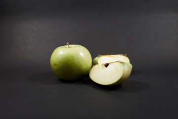 green apples on isolate wooden black table 