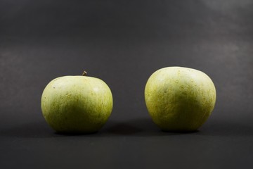 Fototapeta na wymiar green apples on a black background