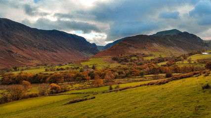 The Newlands Pass scenic valley in autumn with snow capped mountains. Popular destination in the Lake District, Cumbria, United Kingdom. 