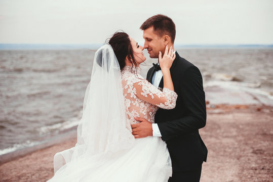 Newlyweds married couple on the ocean coast
