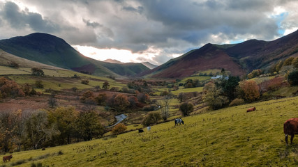 The Newlands Pass scenic valley in autumn with snow capped mountains. Popular destination in the Lake District, Cumbria, United Kingdom. 