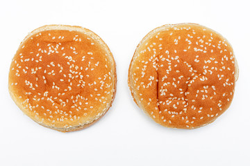 Two Burger buns with sesame, white background, top view