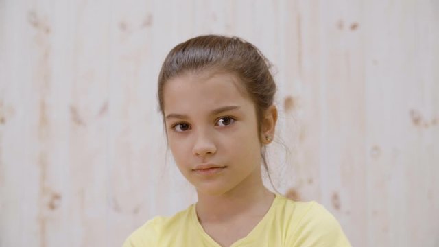 Girl with disgusted facial expression looking at camera. Portrait of cute unhappy teenage girl shaking head and looking at camera