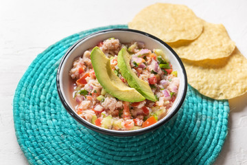 Mexican fish  ceviche with avocado on white background