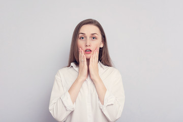 Amazed woman, young girl open mouth widely, react on sudden news