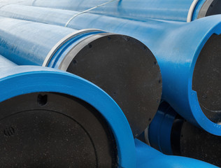 Stack of new blue pipes (tubes)