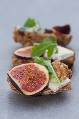 Tasty open sandwiches with fig fruits.